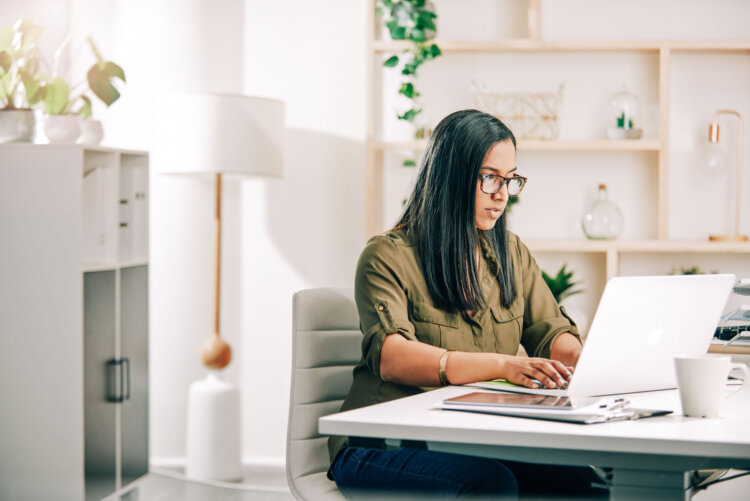 Shot of a young businesswoman working on a laptop in an office