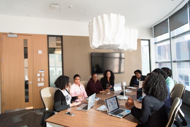 A group of lawyers sits in a boardroom discussing credit card payments