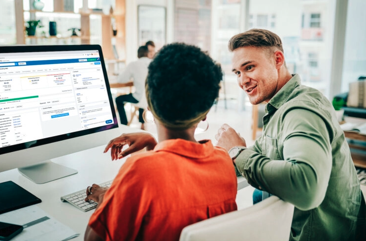 Two lawyers using legal matter management software on a computer