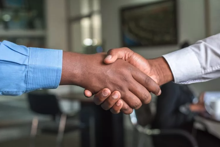 two lawyers clasping hands after working on their law firm strategic planning