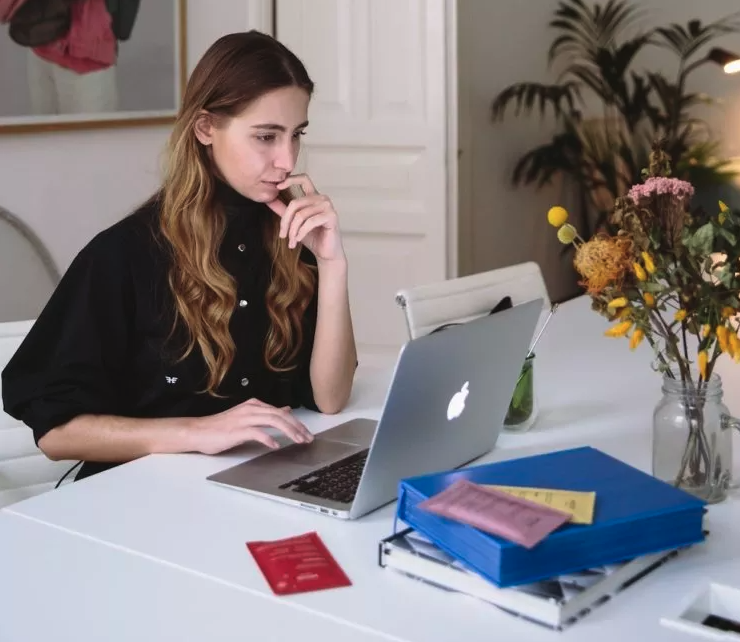 A photo of a lawyer working at a table using Excel for her law firm