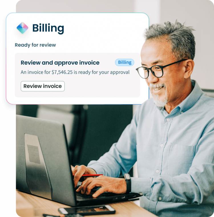 A man smiles while typing on a laptop, with a floating UI bubble showing a Clio Billing notification.