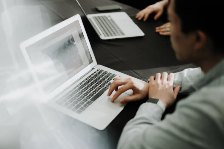 Unfocused image of a lawyer working at a laptop encrypting their law firm's data