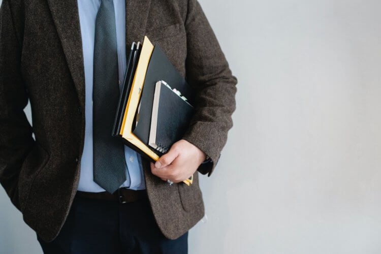 A photo of a lawyer holding confidential client files