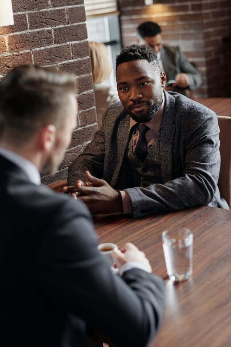 Two professionals discussing referrals at a table