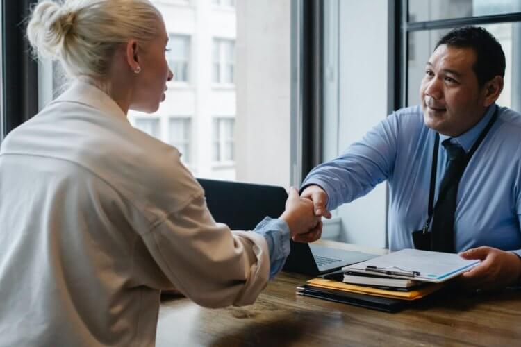 two people shaking hands in an office