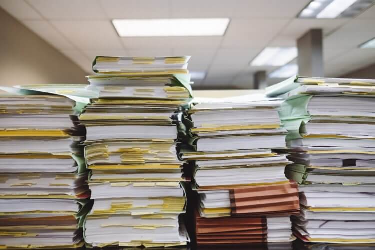 Piles of documents representing how AI is Transforming Legal Documents