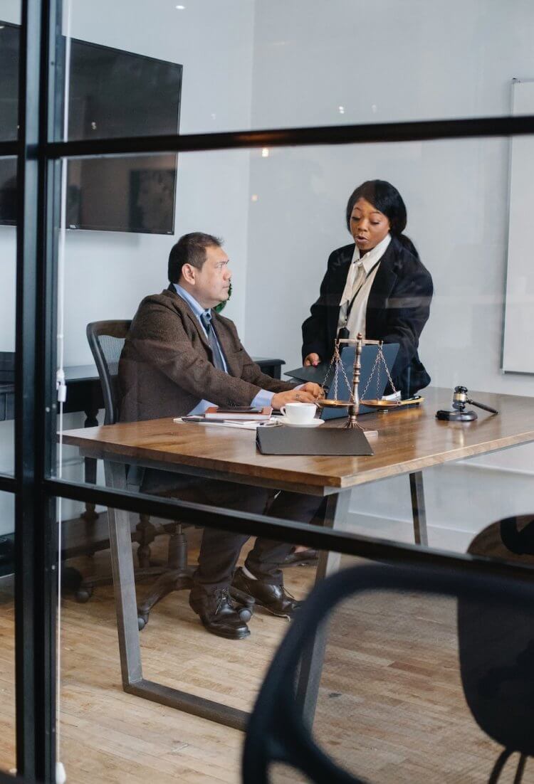 Two legal professionals going over a mistake made in a billing spreadsheet