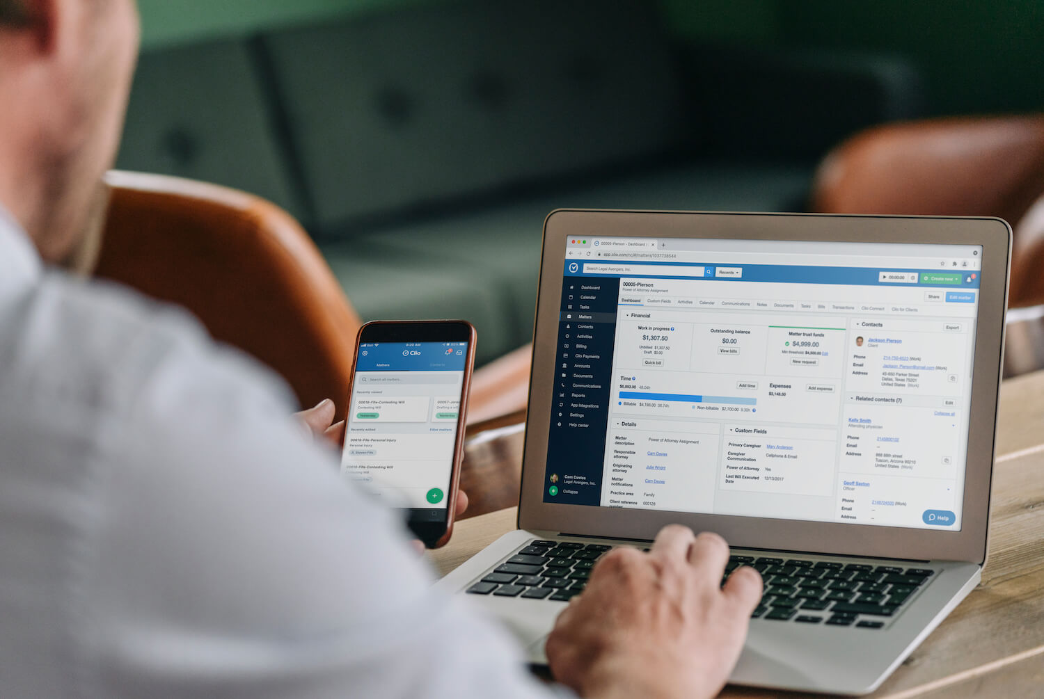 A photo of an attorney using Clio Manage on a laptop and mobile phone