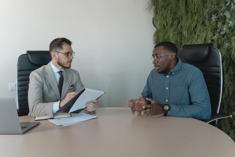 Two people at desk reviewing document