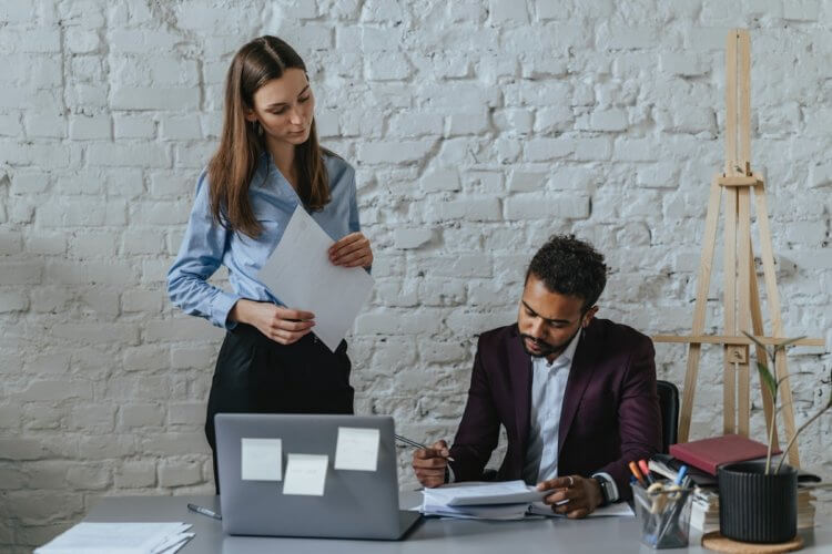 Two lawyers reading the 2022 Legal Trends Report