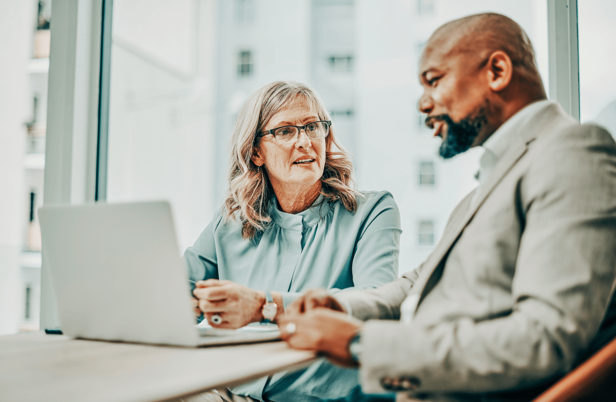 Estate lawyer looking at a laptop with a client