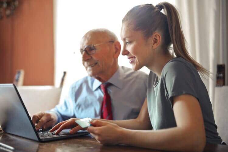 Man and woman paying online bill by credit card