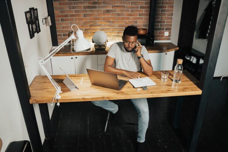 A lawyer sits at his home office, focused on his work.