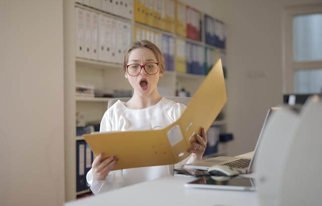 A woman looking at incomplete records.