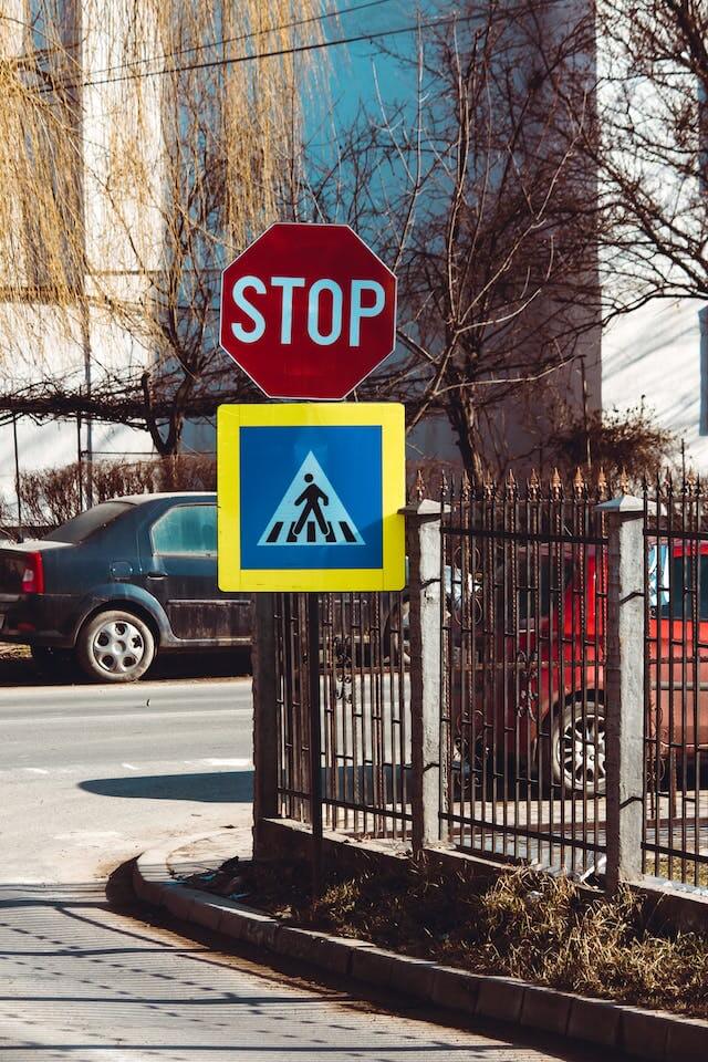 Stop sign with pedestrian crossing symbol.